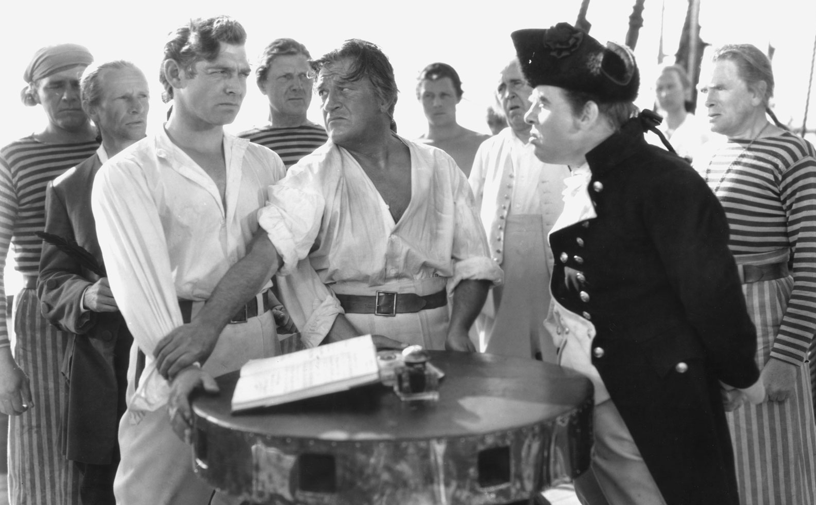 Clark Gable and Charles Laughton lock horns in the tense, seafaring drama "Mutiny on the Bounty." MGM, 1935.
