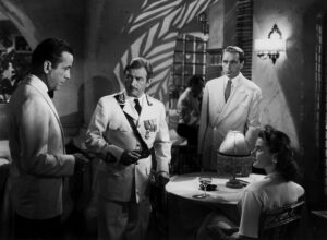 Photo of a fateful encounter in Rick's Cafe with Humphrey Bogart (Rick), Claude Rains (Louis), Paul Henried (Victor), and Ingrid Bergman (Ilsa).