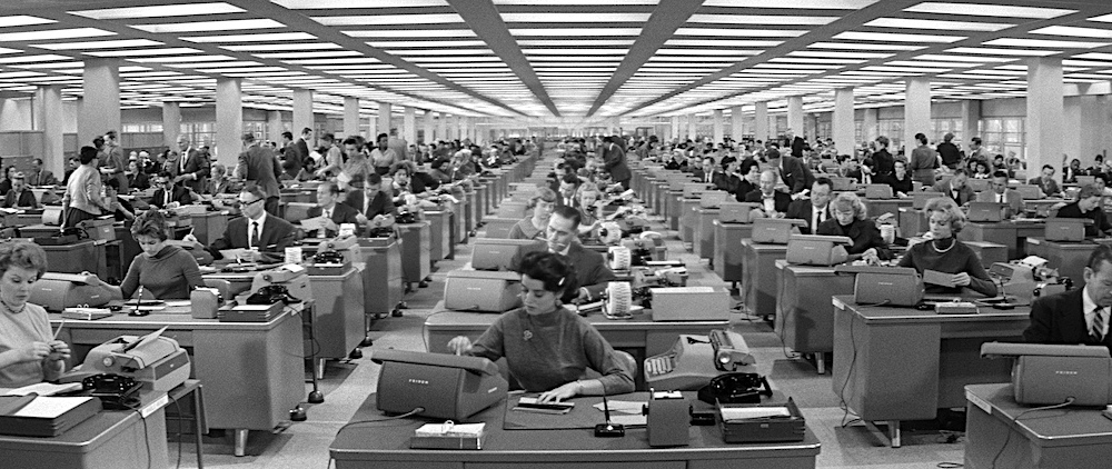 Photo of a large office of workers.