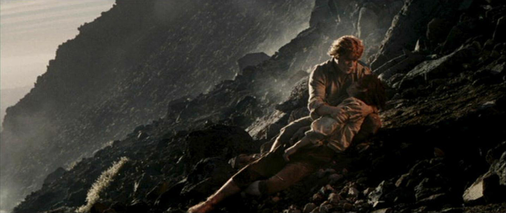 Photo of Sam (Sean Astin) cradling Frodo (Elijah Wood) on Mount Doom.