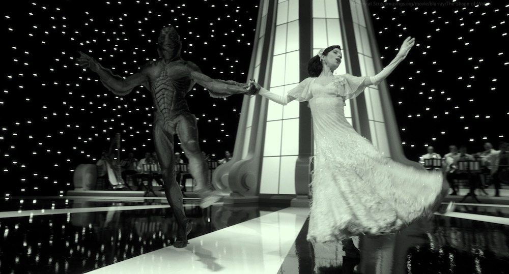 Photo of Doug Jones and Sally Hawkins emulating Fred Astaire and Ginger Rogers.
