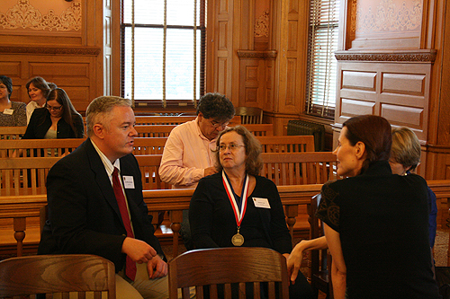 Paul Miles Schneider arrives early (of course) and chats with fellow honorees, including former poet laureate of Kansas, Denise Low (center), and others, at the 2010 Kansas Notable Books ceremony.