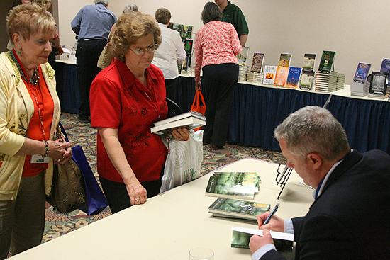 Paul Miles Schneider signs copies of "Silver Shoes" at the Kansas Library Association's annual convention. 2011.