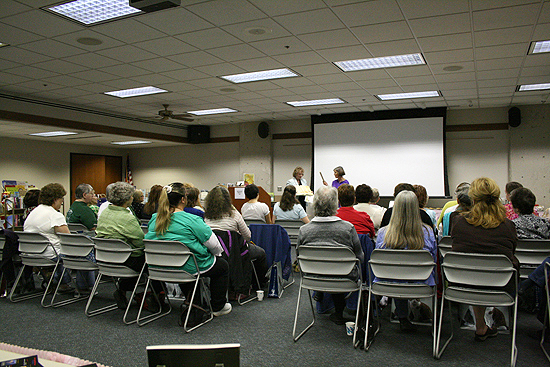 A roomful of librarians listen to several presentations from fellow librarians, guest authors, and book sellers at the NCKLS Annual Book Fair.