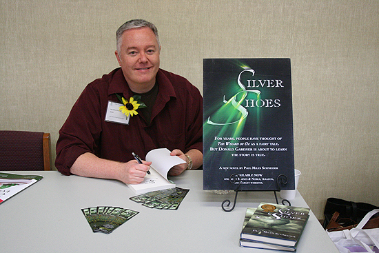 Paul Miles Schneider signs copies of "Silver Shoes" for the afternoon book-signing session of the Kansas Reading Association's 2011 annual convention.