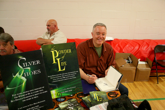 Paul Miles Schneider signs copies of his new book "The Powder of Life" at Chittenango High School on Friday, June 1, 2012.