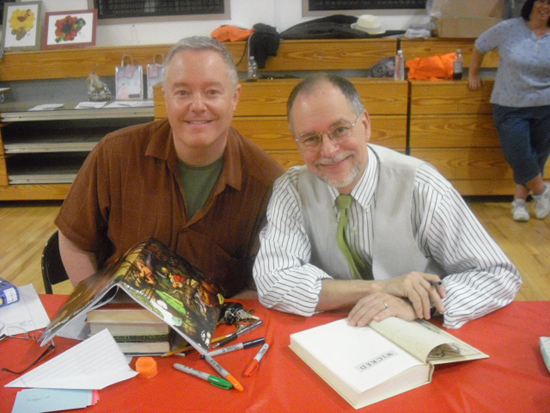 Paul Miles Schneider sits with Gregory Maguire while he signs Paul's first edition of "Wicked: The Life and Times of the Wicked Witch of the West." (Photo courtesy of James C. Wallace II.)
