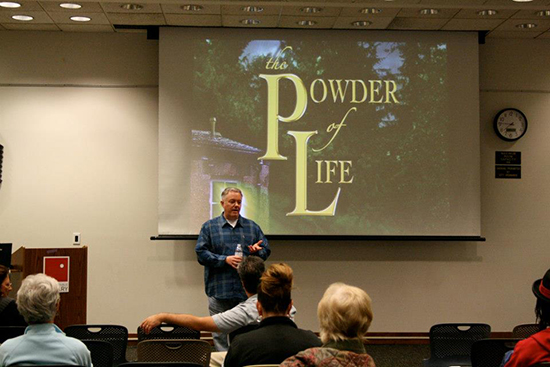 Paul Miles Schneider answers questions after the presentation about his sequel to "Silver Shoes," called "The Powder of Life."