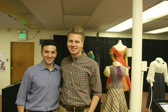 Jonathan Shirshekan and Bobby Remis pause for a millisecond as they continue setting up this ever-growing collection of Judy Garland costumes at the All Things Oz Museum and Gift Shop.