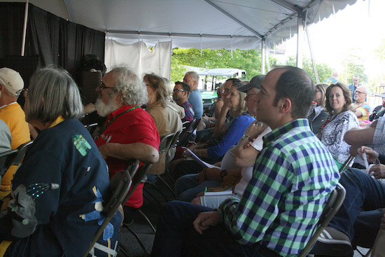 Ryan Jay, Jane Albright, and other attendees watch the Friday evening main-stage program during Oz-Stravaganza! 2014.