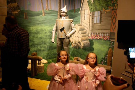 Twin Glindas stop for a photo op, unaware that the Tin Man behind them is about to come to life! Night at the Museum, OZtoberFest 2014, Wamego, Kansas.