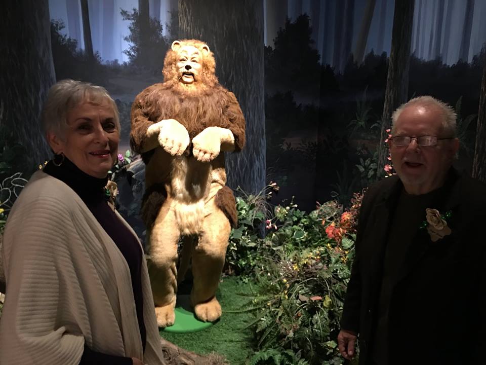 Two "Oz treasures" pose in the Oz Museum next to the Cowardly Lion's display in Wamego, KS, 2016. Charlene Baum, and L. Frank Baum's great-grandson Roger S. Baum.