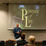 Paul Miles Schneider answers questions after the presentation.